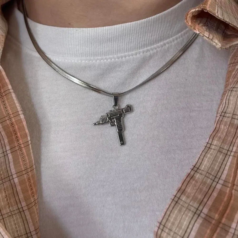 Flat lay silver uzi pendant